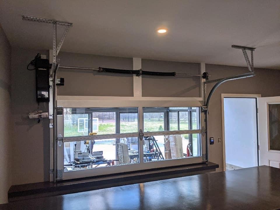 Garage door opener, torsion spring, and track installed in a garage ceiling